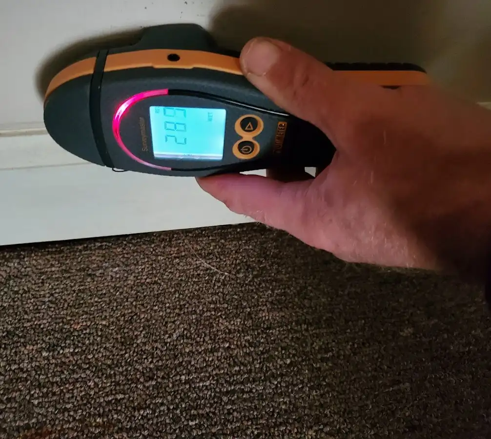 Moisture detection at baseboard during Storm Damage Restoration in Ranson corporation